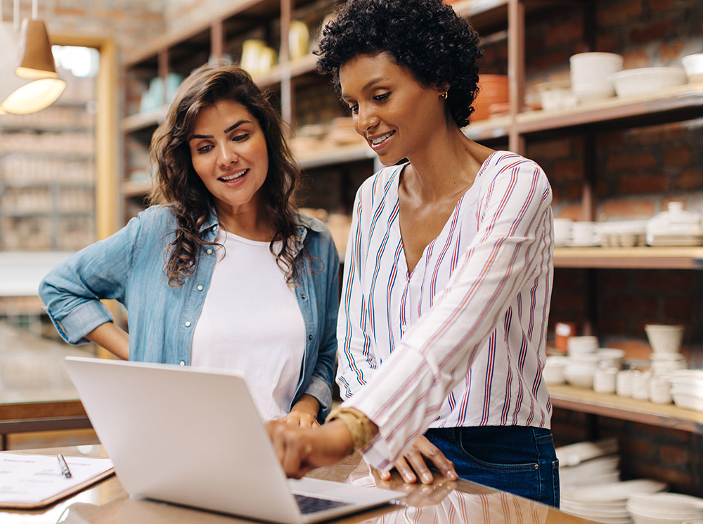 Two business women looking at a laptop